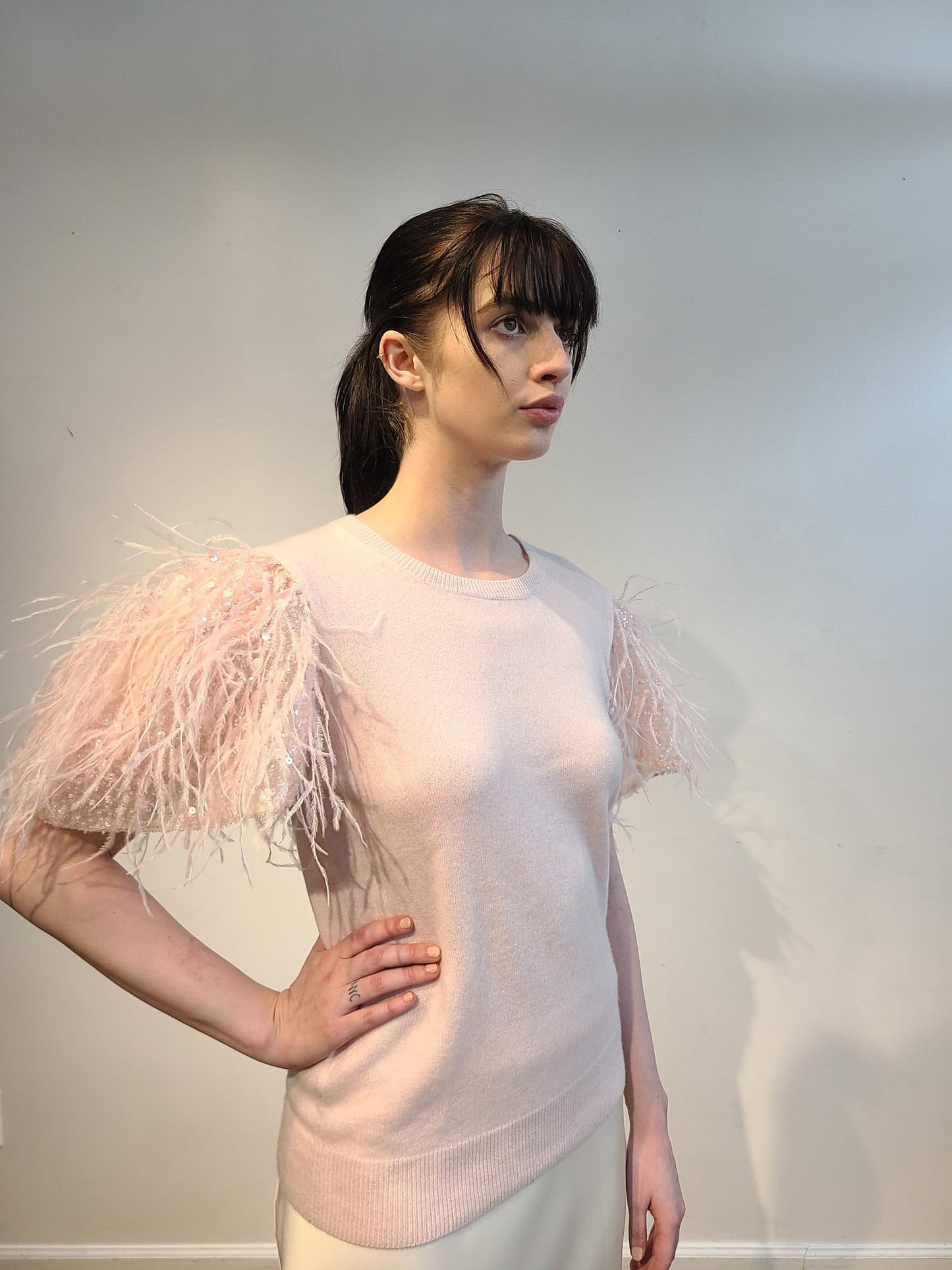 PINK CASHMERE CREW NECK LONG SLEEVE WITH FRONT EMBELLISHED PINK OPALESCENT SEQUINS & FEATHERS FLYING ON PINK TULLE (SIZE L)