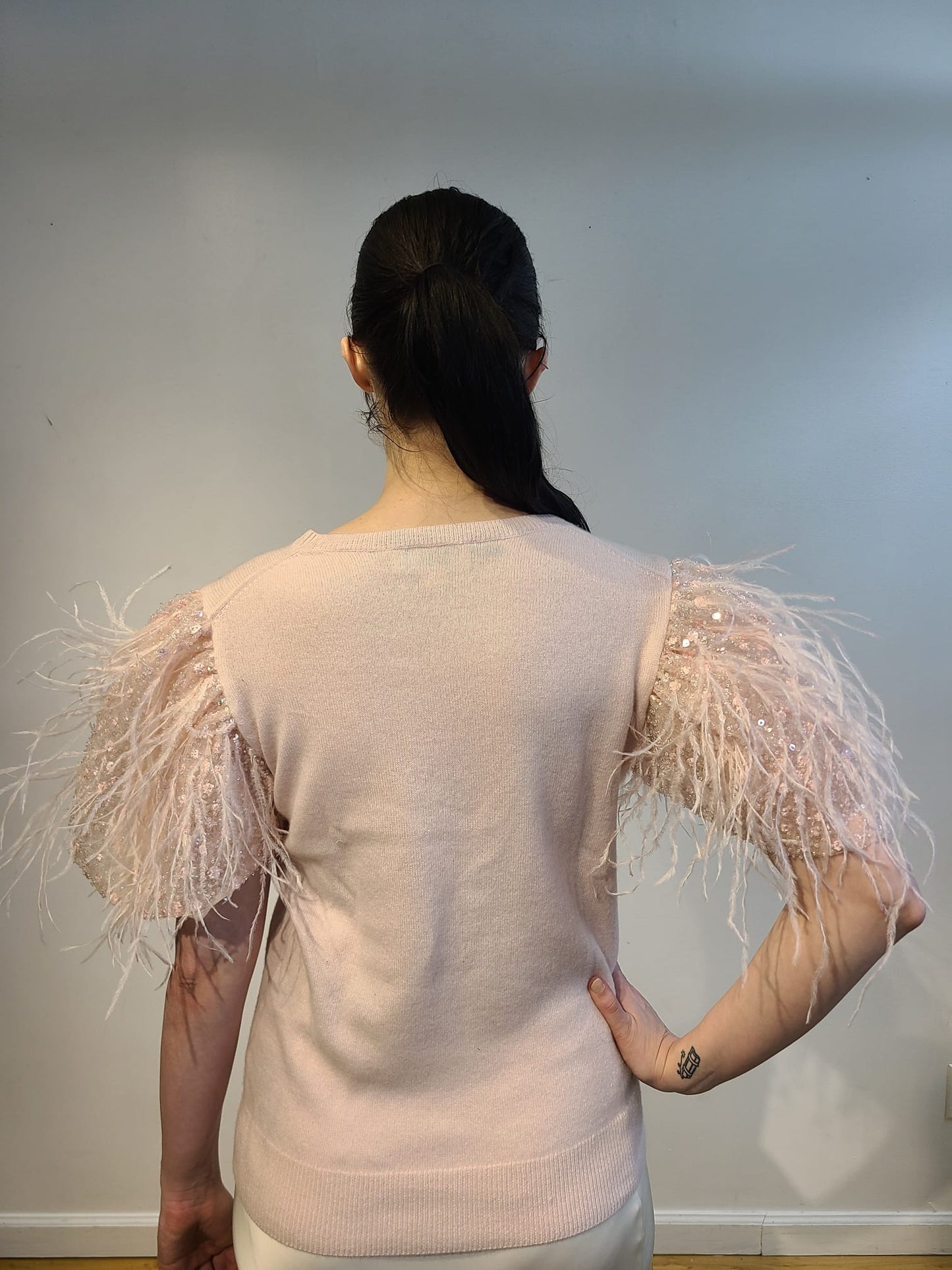 PINK CASHMERE CREW NECK LONG SLEEVE WITH FRONT EMBELLISHED PINK OPALESCENT SEQUINS & FEATHERS FLYING ON PINK TULLE (SIZE L)