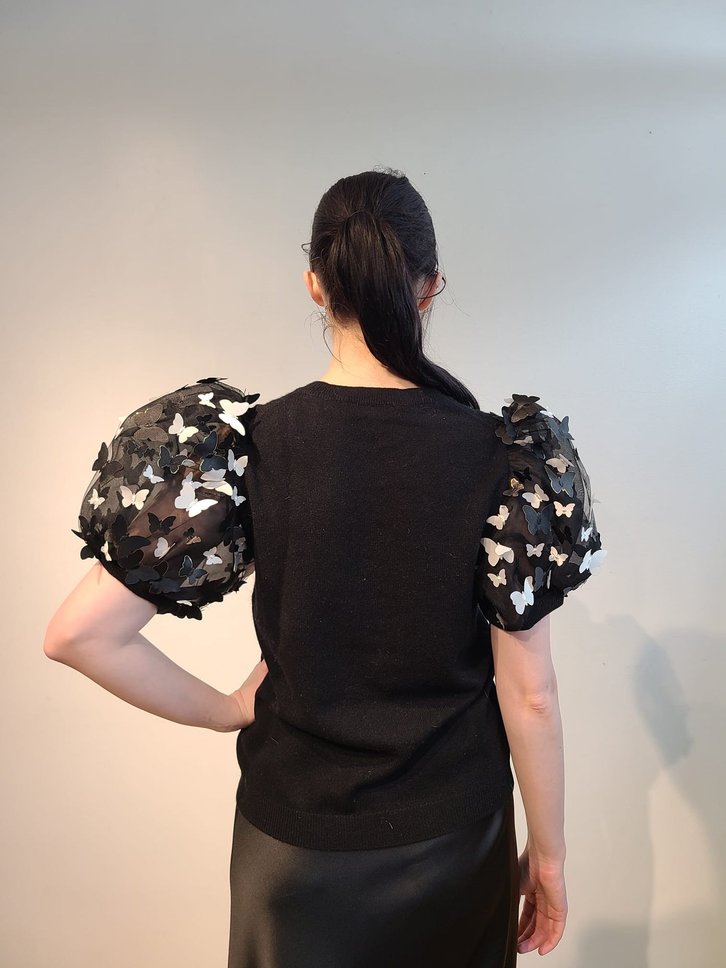 BLACK CASHMERE T SHIRT WITH VOLUMINOUS SHORT PUFF SLEEVE EMBELLISHED OF BLACK & WHITE 3D BUTTERFLIES WITH GOLD TRIM FLYING FREE (SIZE L)