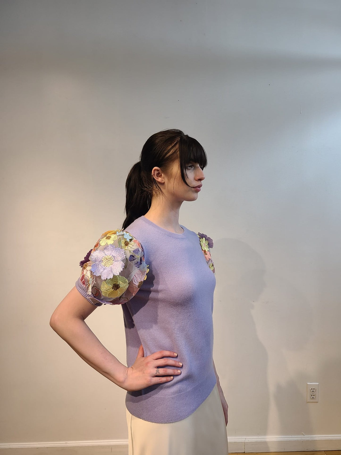 LAVENDER CASHMERE CREW NECK WITH SHORT PUFF SLEEVE EMBElLISHED WITH PINK/CORAL/YELLOW AND LAVENDER FLOWERS ON BABY BLUE TULLE & SLEEVES (SIZE S)
