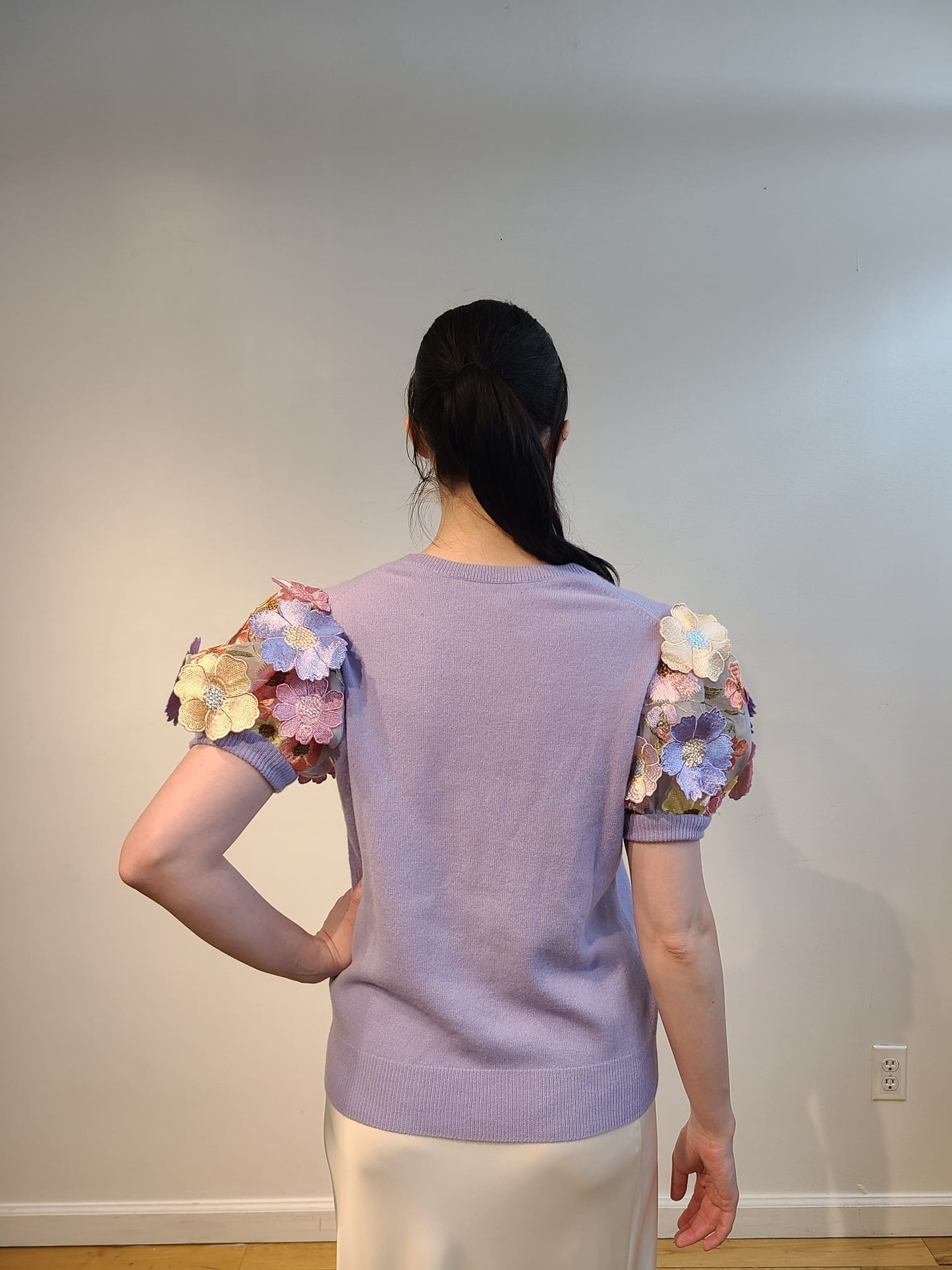 LAVENDER CASHMERE CREW NECK WITH SHORT PUFF SLEEVE EMBElLISHED WITH PINK/CORAL/YELLOW AND LAVENDER FLOWERS ON BABY BLUE TULLE & SLEEVES (SIZE S)