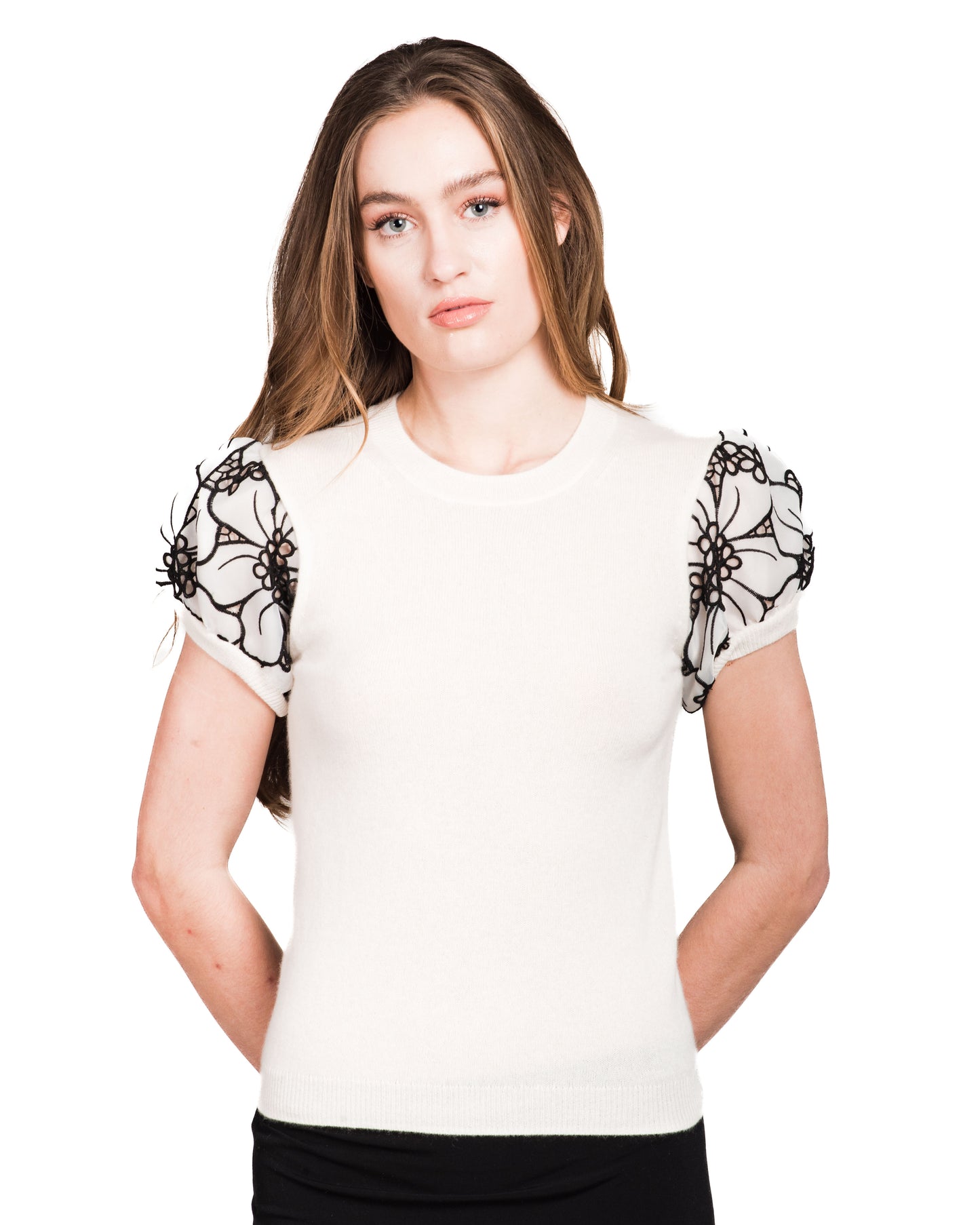SMALL WHITE CREW NECK CASHMERE SWEATER WITH SHORT PUFF SLEEVES OF WHITE SILK ORGANZA FLOWERS WITH BLACK OVERSTITCHED TRIM AND PETITE FLORAL CUTOUTS